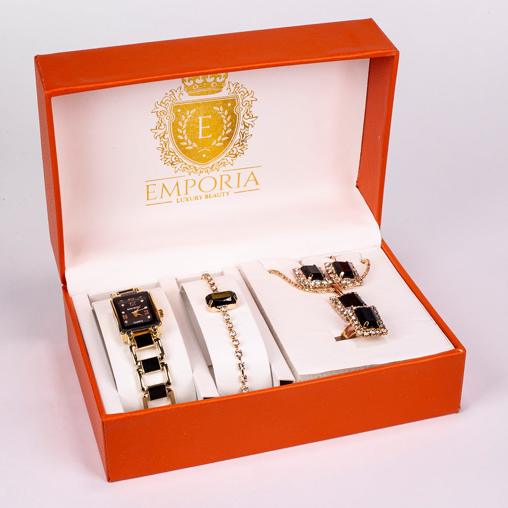 Set premium Emporia, compus din 5 piese în tonuri aurii, prezentat într-o cutie cadou exclusivă cu aspect de piele (ceas, brățară, colier, cercei și inel, decorate cu cristale negre și albe Emporia). 1 
